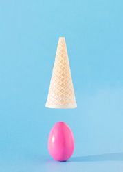 Pink egg with upside down ice cream cone above