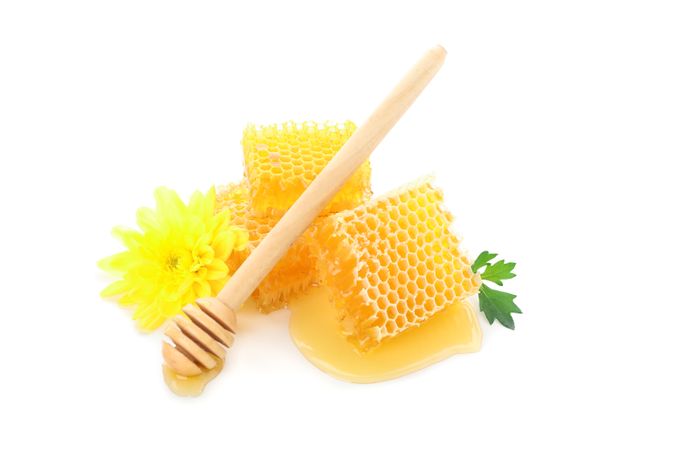 Pieces of honeycomb, chrysanthemum and dipper isolated on plain background