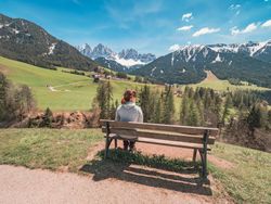 woman admiring the views of Small beautiful village between mountains with snow