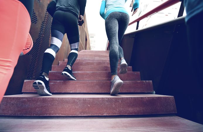 Picture of people in leggings running up stairs