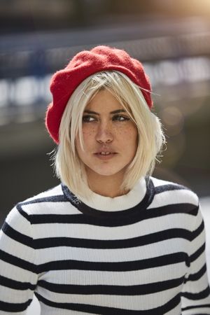 female in red beret outdoors