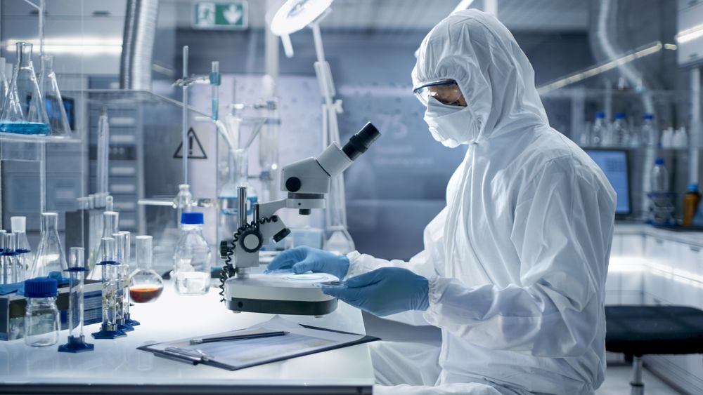 In a Secure High Level Laboratory Scientists in a Coverall Conducting a Research.