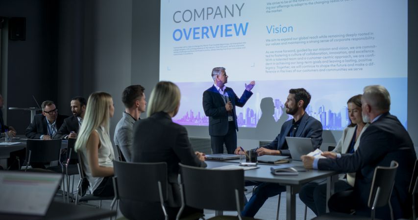 Corporate Event: Male Tech CEO Giving Presentation To Colleagues, Investors In Conference Room Of Innovative Startup Office.