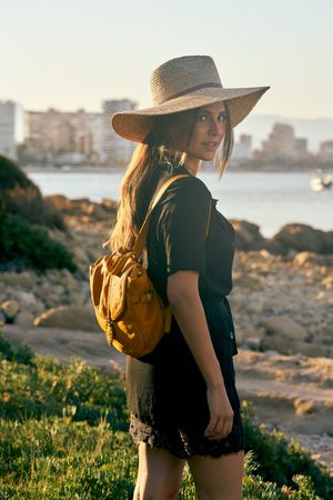 Woman traveler in straw hat walking
