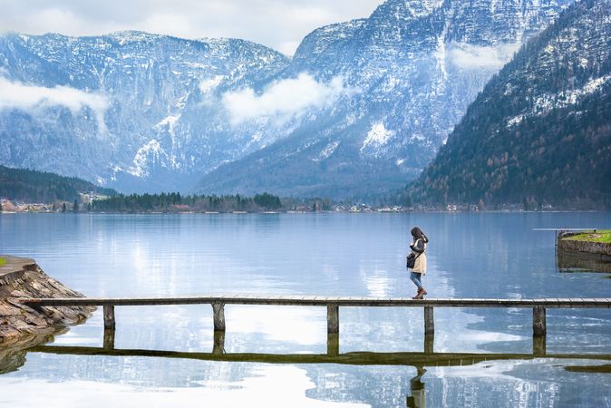 Woman walking on a deck over an alpine lake
