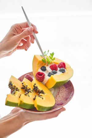 Crop person having delicious healthy dessert