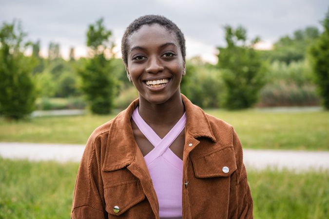 Smiling Black woman standing in park