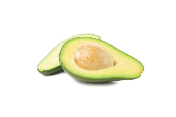 Ripe avocado halves isolated on blank background