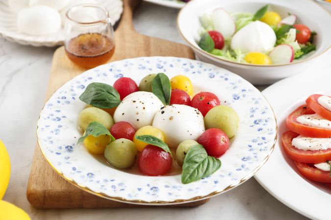 Bocconcini Mozza Balls Cheese with Fresh Casil Leaves in Caprese Salad.