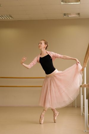 Ballet dancer lifting skirt gracefully