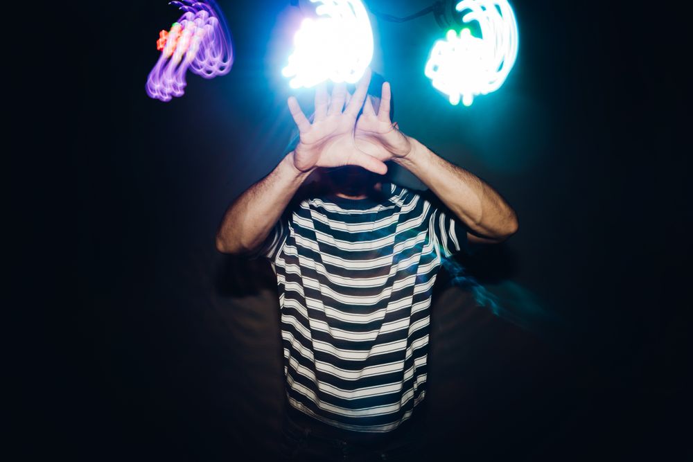 bearded man dancing in spotlight