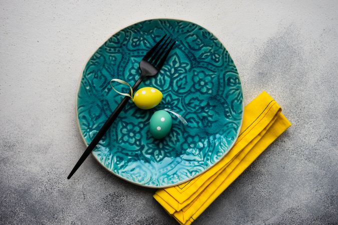Easter table setting with blue plate and yellow napkin