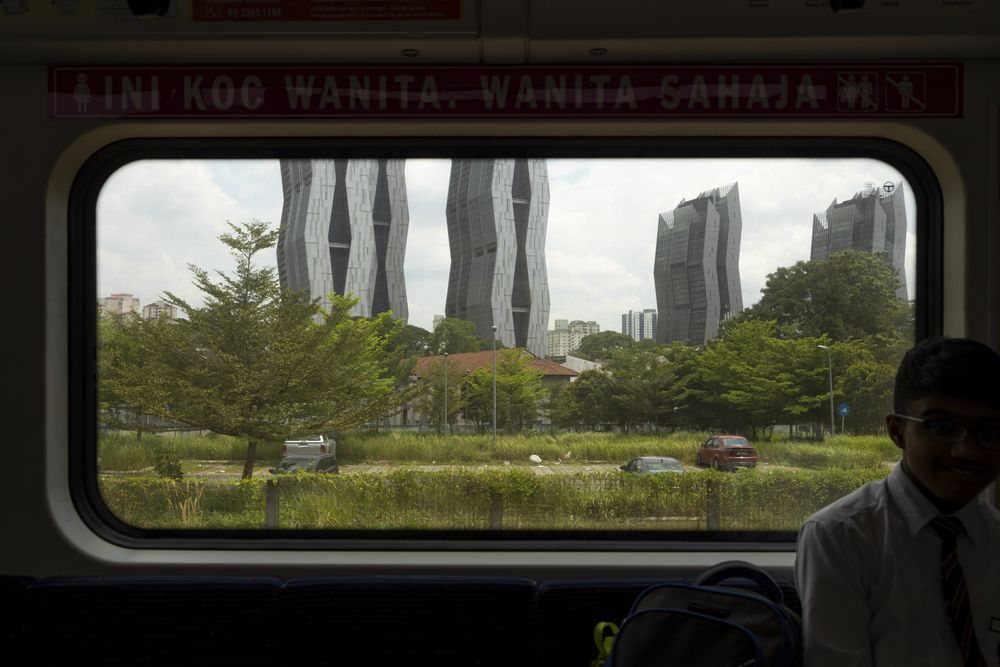 Window from inside the KTM train line, in Kuala Lumpur, Malaysia, heading towards Batu caves