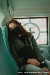 Woman with facemask sleeping in bus 56yoN0