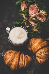 Coffee with croissants and pink roses