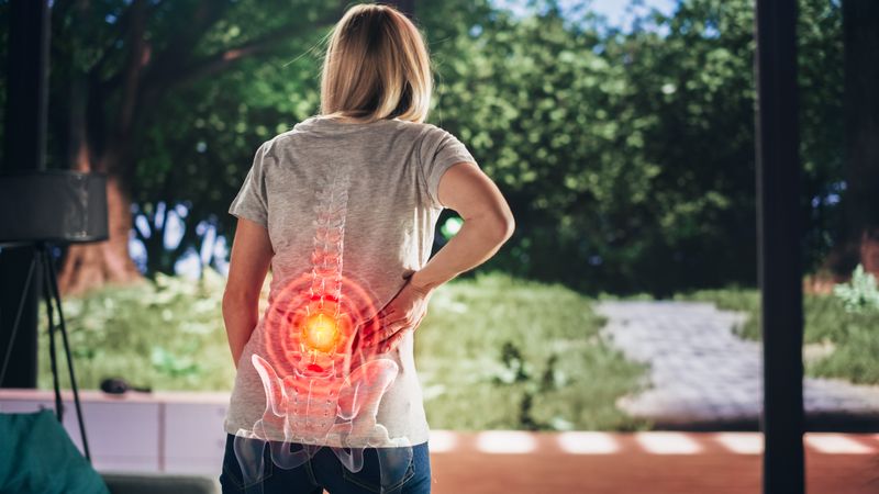 VFX Back Pain Augmented Reality Render. Close Up of a Female Experiencing Discomfort in a Result of Spine Trauma or Arthritis.