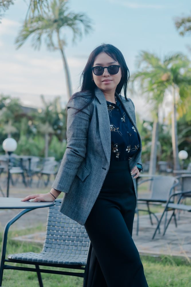 Stylish businesswoman enjoying tropical scenery during work break