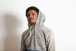 Man in grey hoodie looking at camera