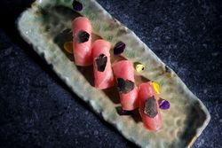 Palatable sushi on ceramic plate in row