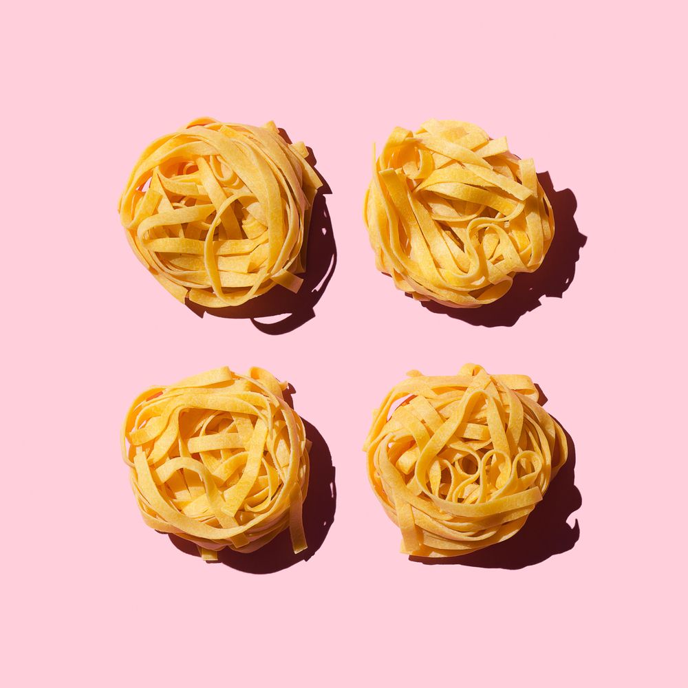 Bird's nest pasta organized over pink background