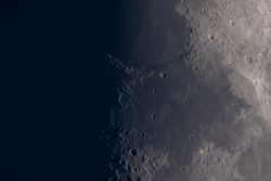 Waxing Moon close-up revealing shadowed lunar craters and plains.