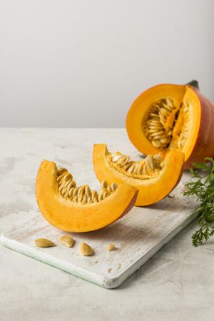 Pumpkin slices with seeds arranged on tray