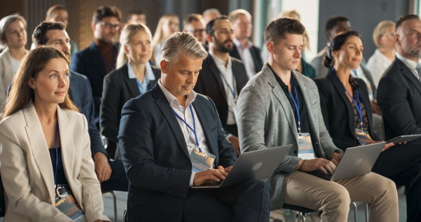 Successful Businessman Listening To Presentations About Environment, Developing Countries, Technology.
