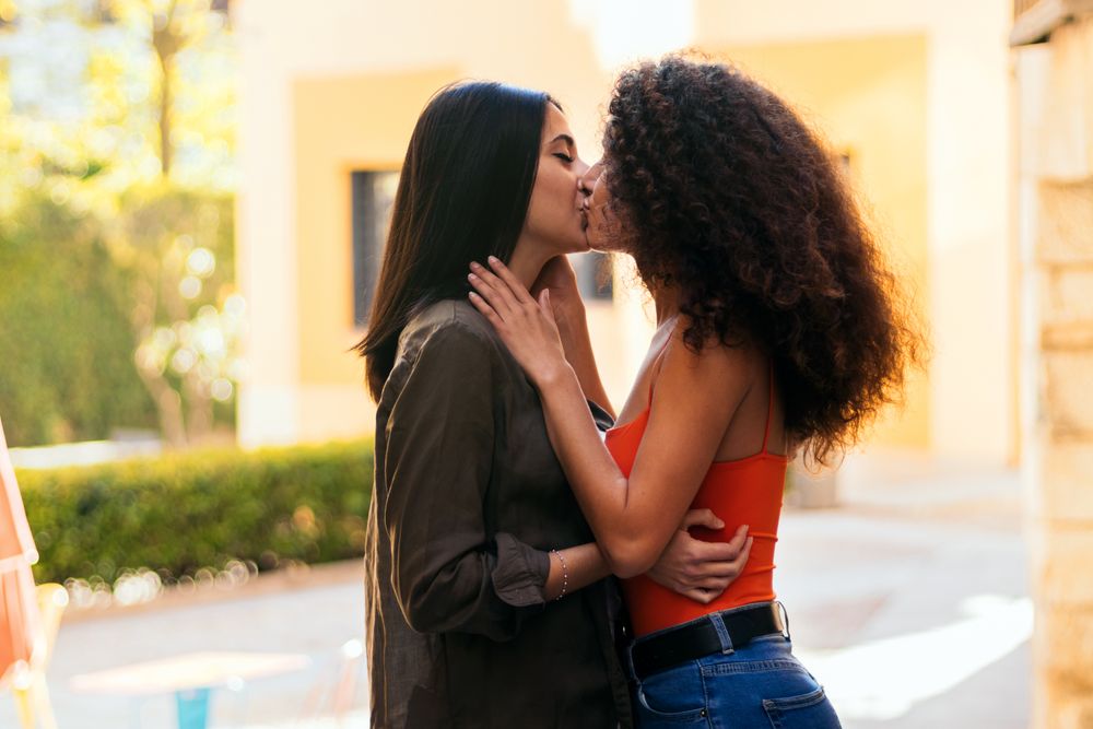 two young women, lesbian couple kissing