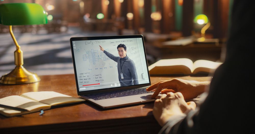 Asian Male Professional Presenting a Business Strategy on a Laptop Screen
