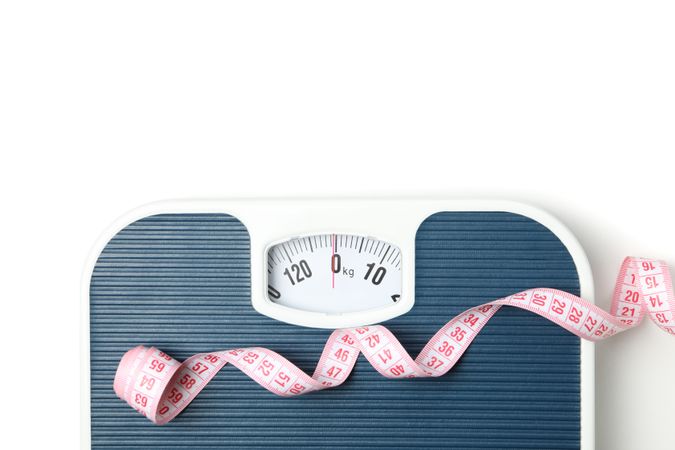 Scales and measuring tape isolated on light background