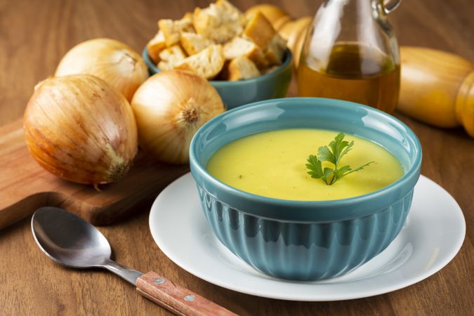 Bowl with onion soup and croutons on the table.