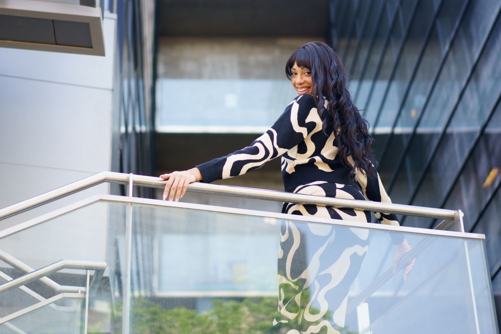 Sensual dancer turning to look down from urban viewpoint