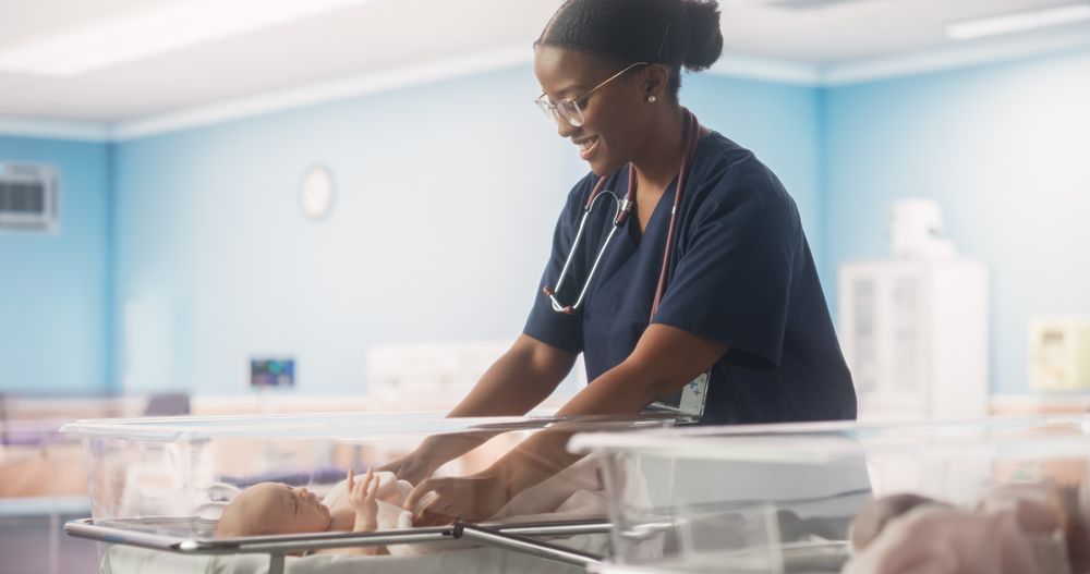 Black Pediatrician Covering Child with Blanket.