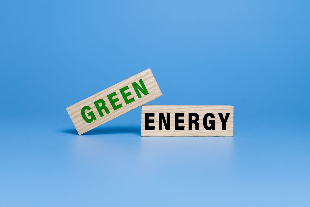 green energy words text on wooden blocks isolated on blue background