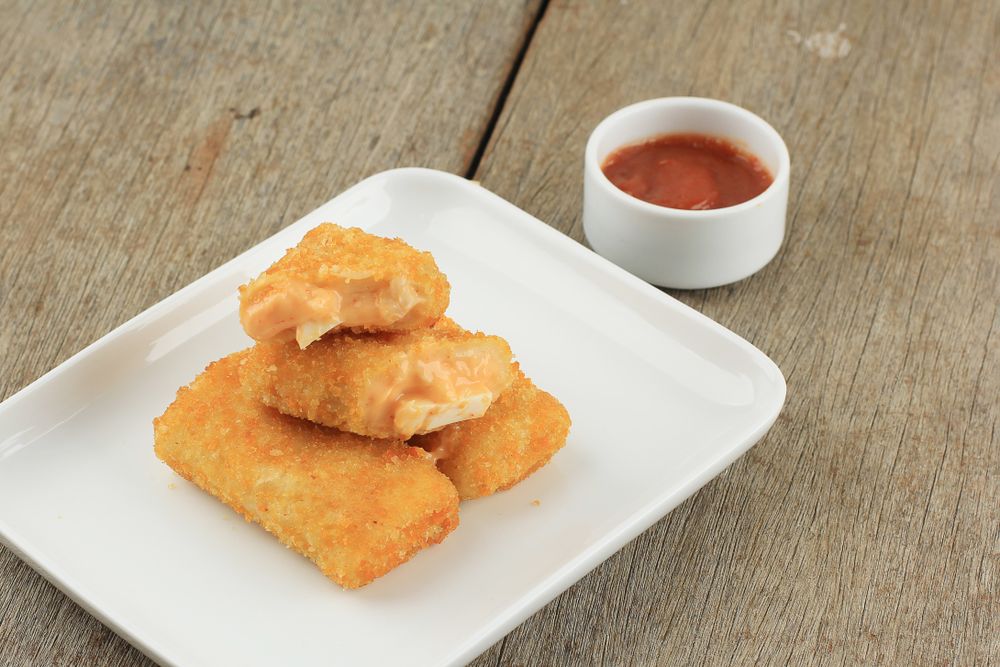 Plate of risol mayo keju, fried thin crepes rolled with egg and mayonnaise filling