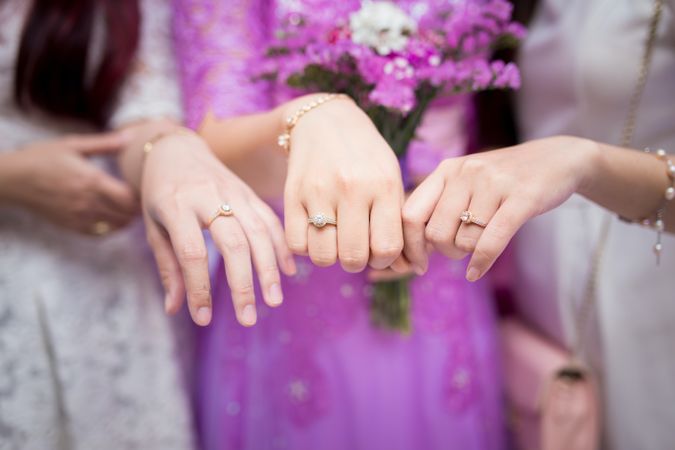 Cropped image of three women wearing engagement ring