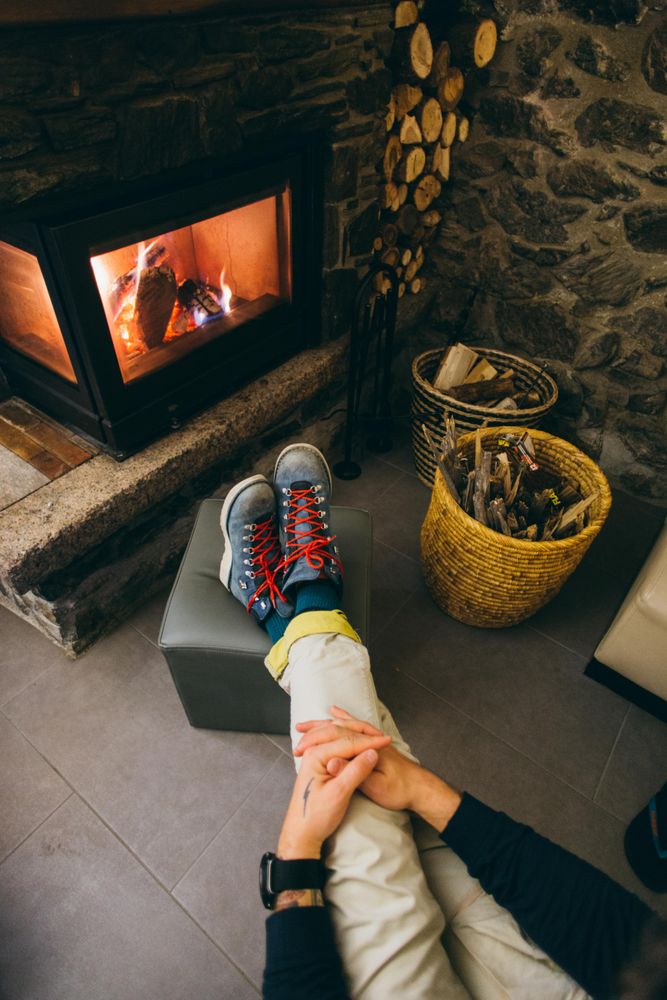 Man resting warmly by the fireplace