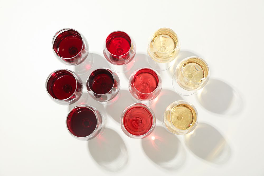 Flat lay composition. Glasses with different wine on blank background, top view