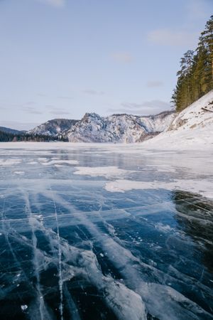 Frozen river ice with cracks