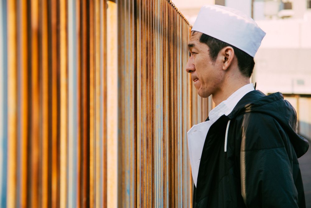 Man wearing Japanese chef hat outdoor in the city