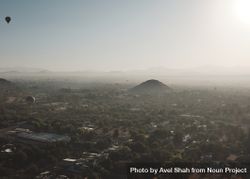 Hot air balloons flying above hazy morning in Teotihuacan Valley 5692d0