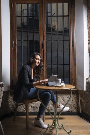 Young female using digital tablet in cafe