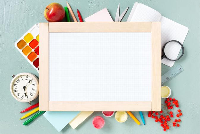 Blank writing board surrounded by stationary