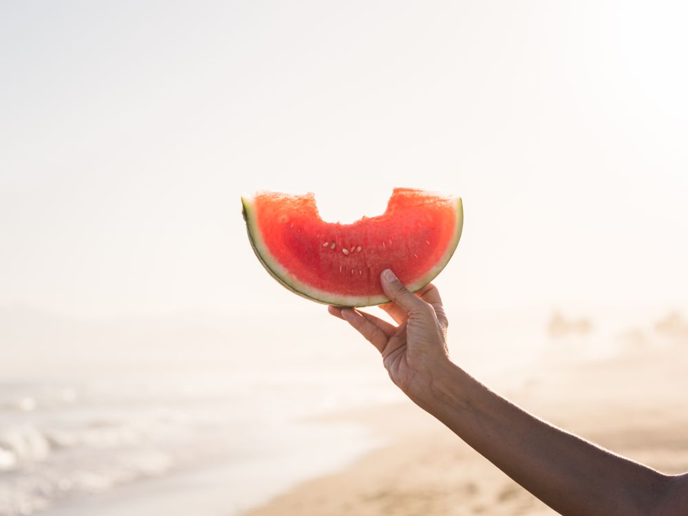 Hand of a person holding red watermelon