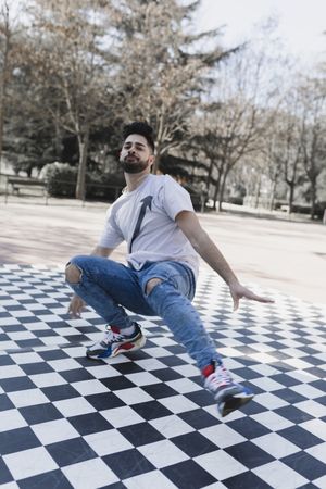 Man dancing break dance in park