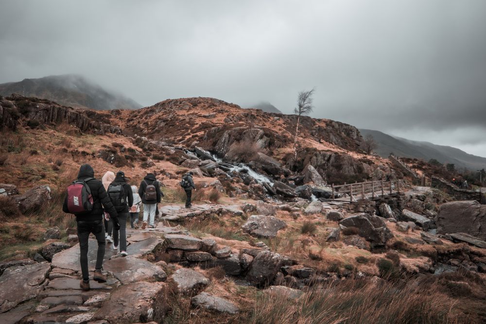 People with backpacks hiking on rocky mountain