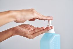 Anonymous person applying sanitizer on hand