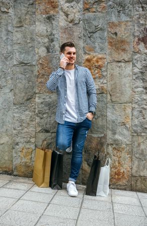 Man with shopping bags and mobile