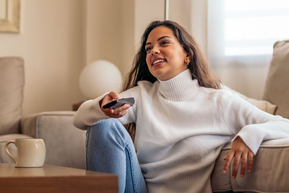At-home entertainment: young woman enjoying television