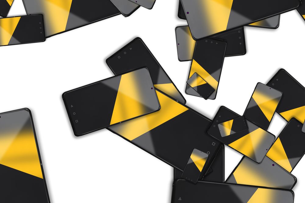 Mobile phones scattered on a bright background